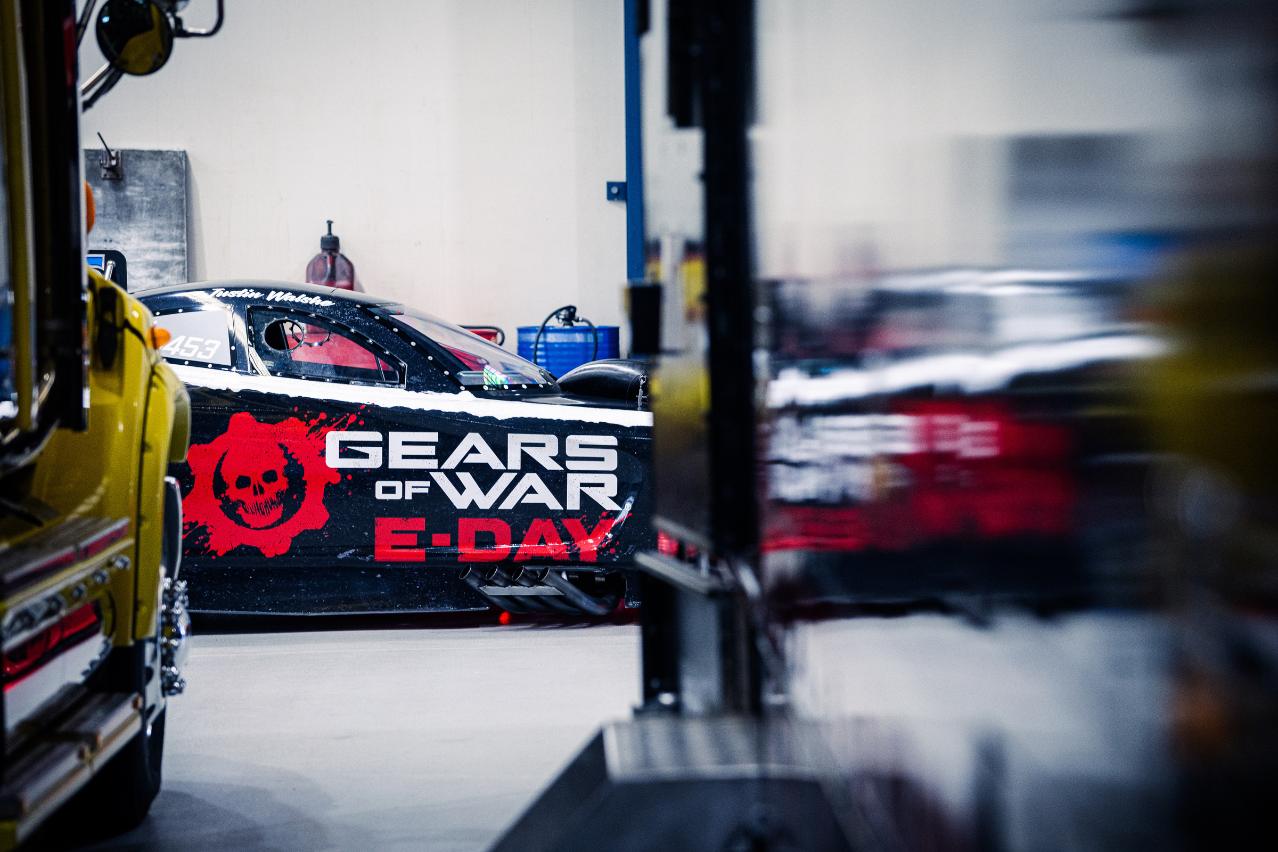Xbox Gears of War: E-Day Nitro Funny Car featuring its black, white and red livery inside the Aeroflow workshop.