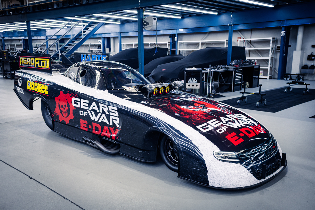 Three-quarter workshop view of the Xbox Gears of War: E-Day Nitro Funny Car featuring its full NDRC livery.