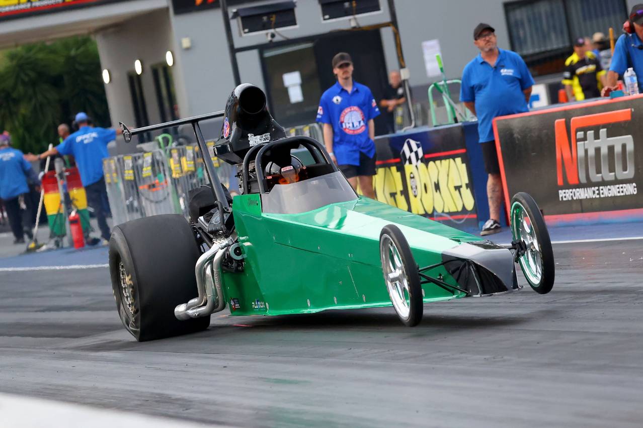 Brooke Rapisarda’s green Modified dragster driving on track at Sydney Dragway.