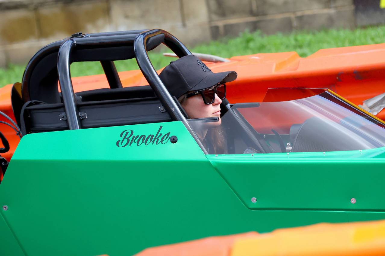 Brooke Rapisarda seated in the cockpit of her green Modified dragster.