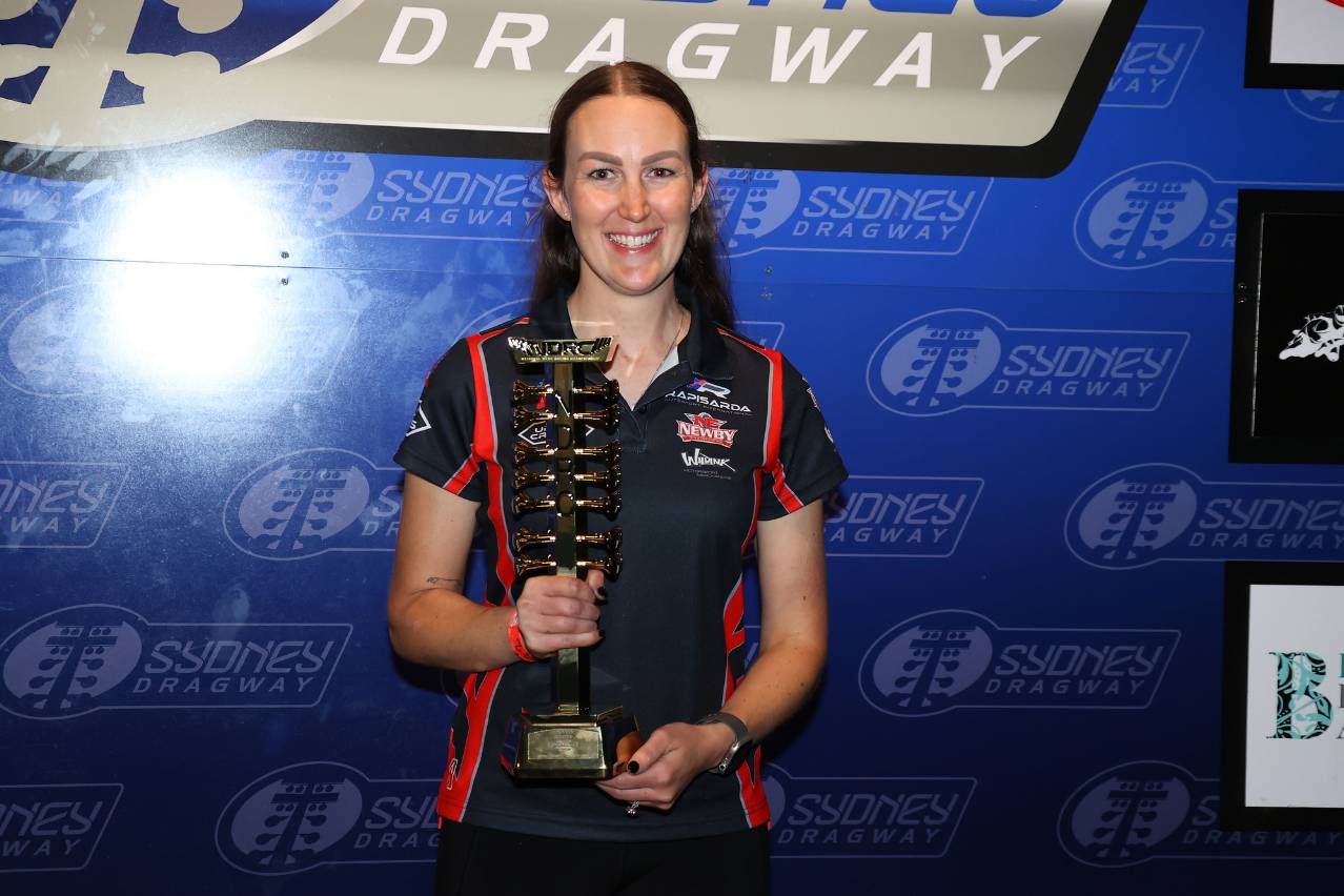 Brooke Rapisarda celebrates with a trophy at Sydney Dragway.